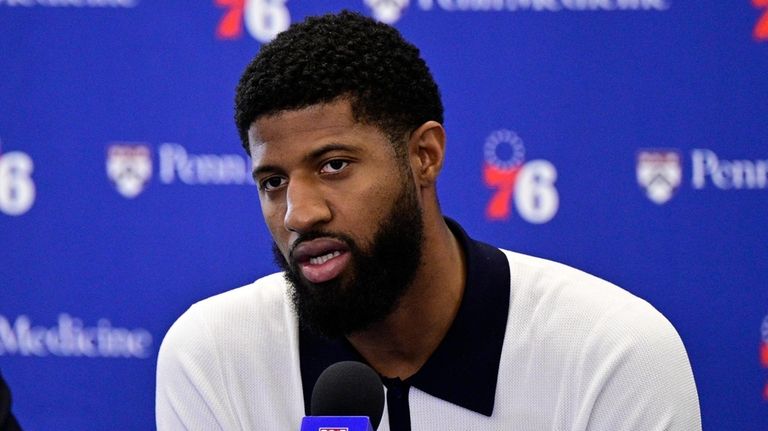 Philadelphia 76ers' Paul George speaks with members of the media...