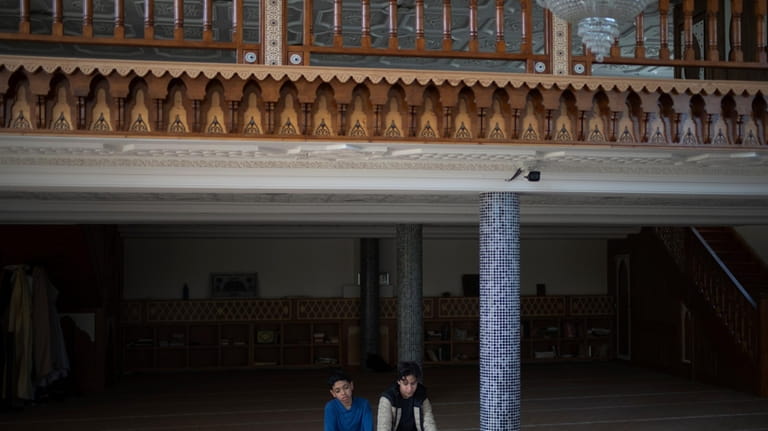 Students pray during recess in the mosque at Ibn Khaldoun,...