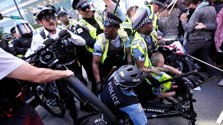 Demonstrators clash with police near the Israeli Consulate during the...