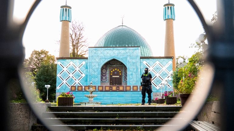 A police officer stands outside the Islamic Center Hamburg with...