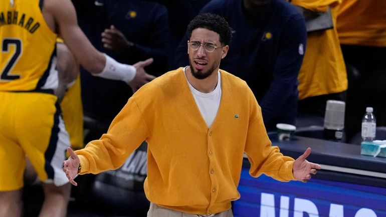 Injured Indiana Pacers guard Tyrese Haliburton reacts during the first...