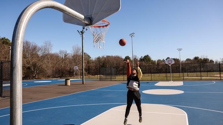 Angel Scrubb of Medford shoots hoops at the Granny Road Park basketball...