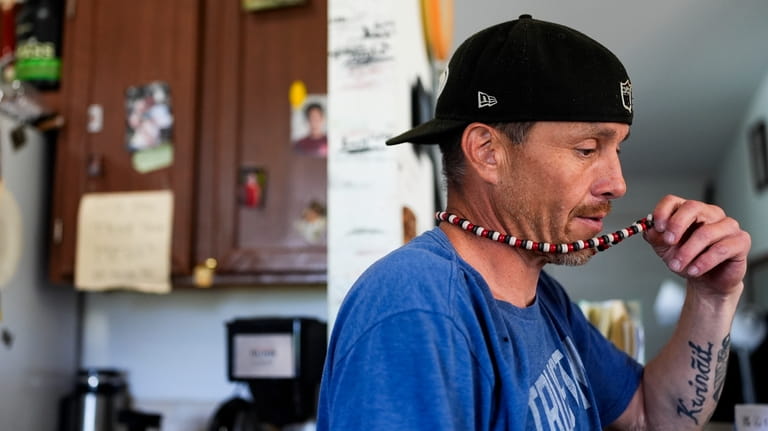 Sonny Curley holds his necklace as he speaks about the...