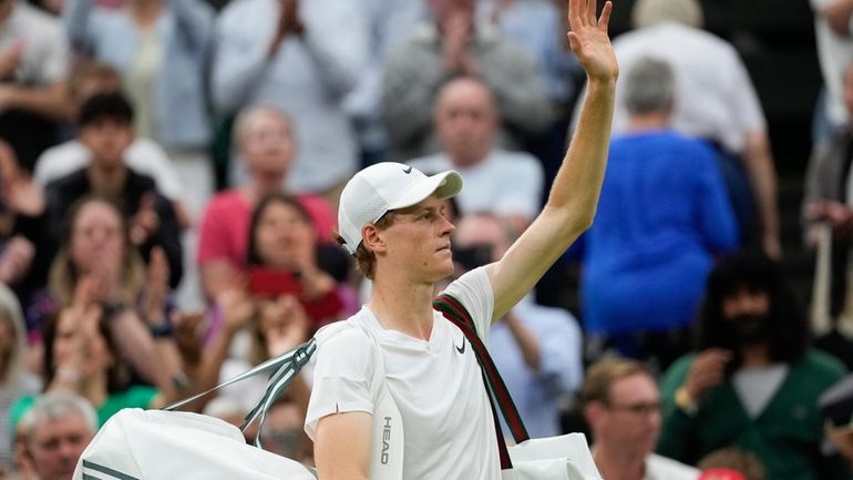 Jannik Sinner of Italy waves as he leaves the court...