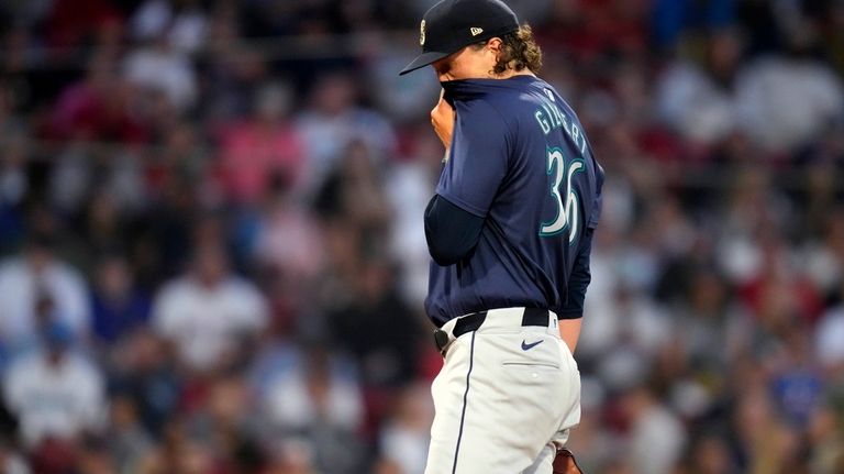 Seattle Mariners pitcher Logan Gilbert reacts after giving up a...