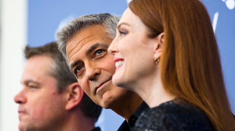 Actor George Clooney, center, poses with actors, Julianne Moore, right,...