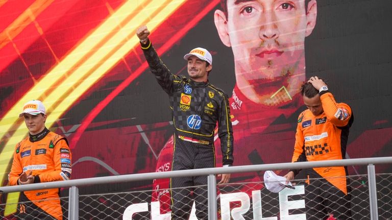 Ferrari driver Charles Leclerc of Monaco, centre, celebrates on the...