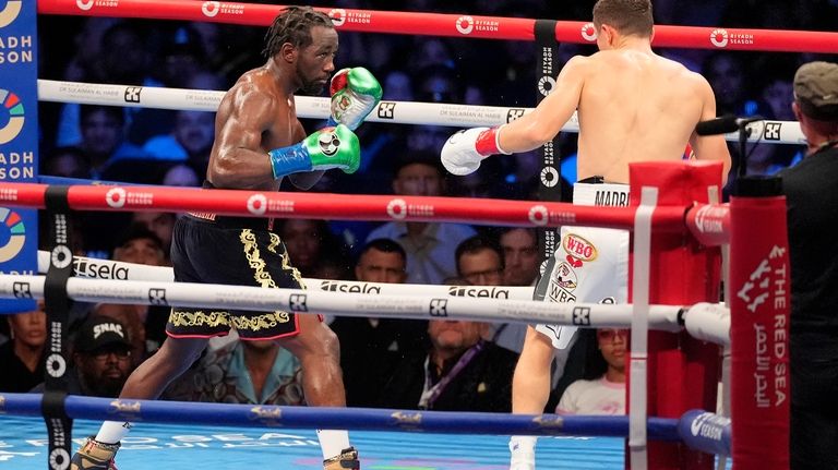 Terence Crawford, left, fights Israil Madrimov during a super welterweight...