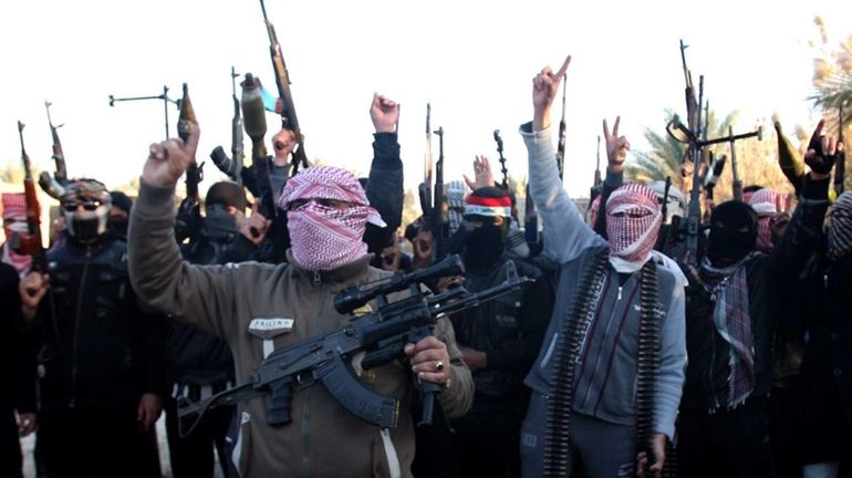 Masked Sunni gunmen chant slogans against the Iraqi Shiite-led government...