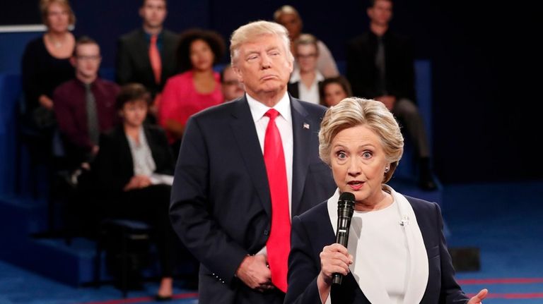 Democratic presidential nominee Hillary Clinton, right, speaks as Republican presidential...