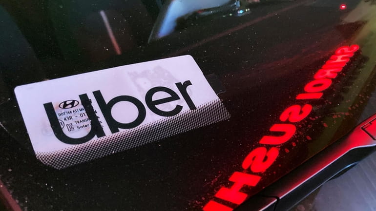 An Uber sign is displayed inside a car in Glenview,...