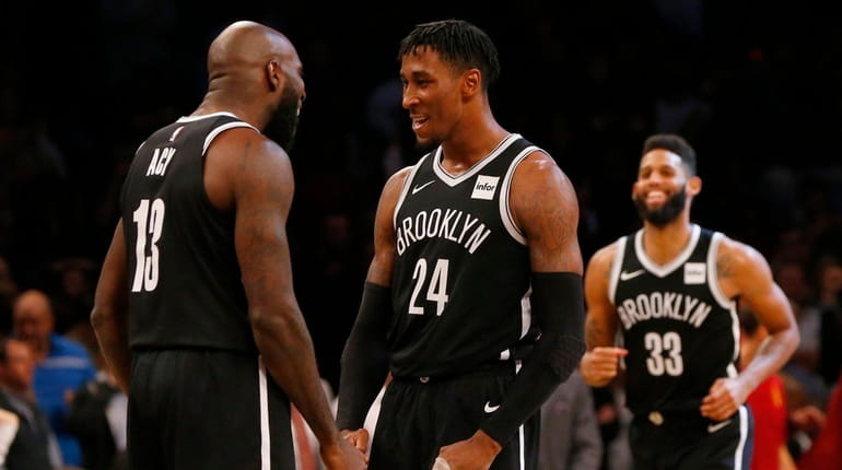 Rondae Hollis-Jefferson and Quincy Acy of the Nets react after...