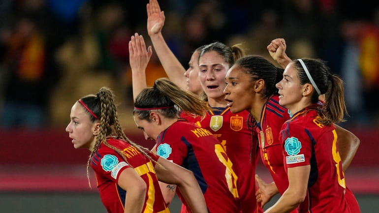 Spain's Aitana Bonmatí celebrates with teammates after scoring her side's...