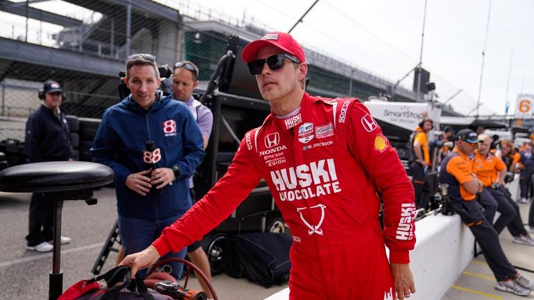 Marcus Ericsson, of Sweden, carries his gear after a session...