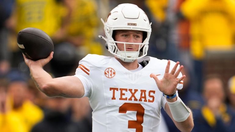 Texas quarterback Quinn Ewers throws against Michigan in the first...