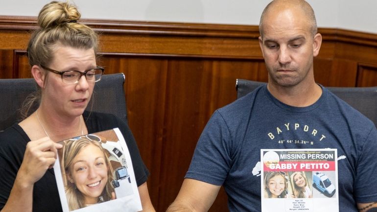 Nichole Schmidt holds a photo of her daughter Gabby Petito...