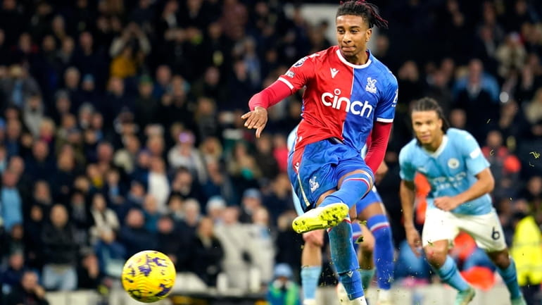 Crystal Palace's Michael Olise shoots a penalty kick to score...