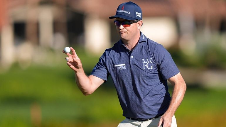 Zach Johnson reacts after finishing on the 18th hole of...