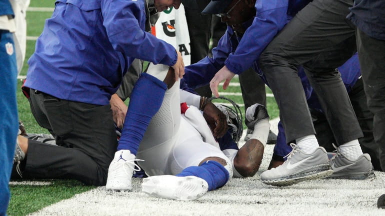 Giants quarterback Tyrod Taylor is tended to after getting hurt...
