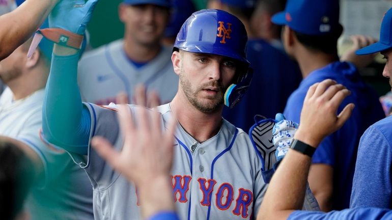 Pete Alonso  of the Mets celebrates his home run with teammates...