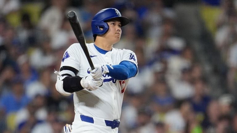 Los Angeles Dodgers' Shohei Ohtani watches his two-run double during...