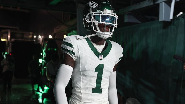 Cornerback Sauce Gardner of the New York Jets walks out onto...