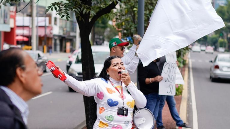 Unionized federal court workers shout slogans outside a federal court...