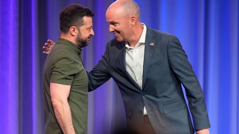 Utah Gov. Spencer Cox, right, greets Ukraine's President Volodymyr Zelenskyy,...