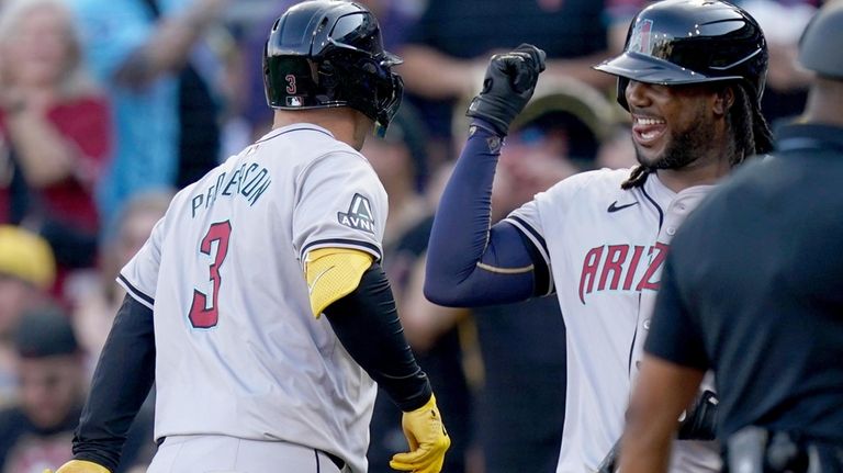 Arizona Diamondbacks' Joc Pederson, left, is greeted by Josh Bell,...