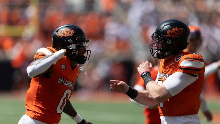 Oklahoma State running back Ollie Gordon II (0) and quarterback...