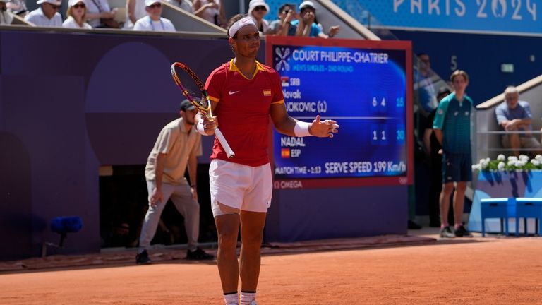 Spain's Rafael Nadal reacts as he plays Serbia's Novak Djokovic...