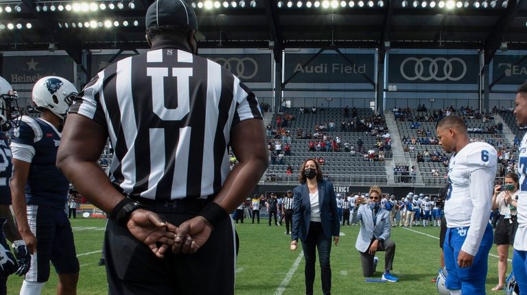 Vice President Kamala Harris takes part in the ceremonial coin...