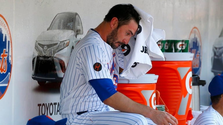 Matt Harvey of the Mets sits in the dugout after...