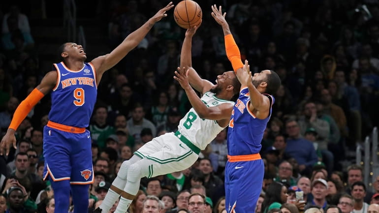 Boston Celtics guard Kemba Walker (8) shoots between New York...