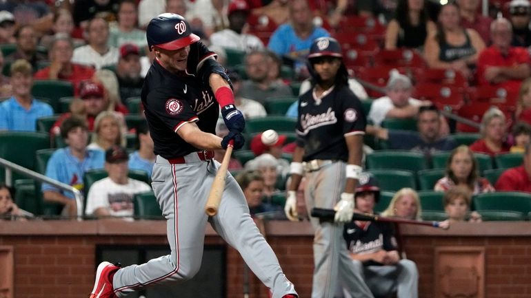 Washington Nationals' Jacob Young hits a three-run triple during the...