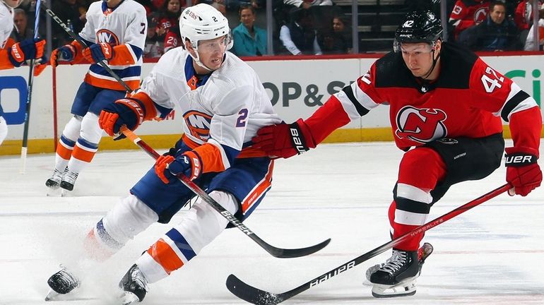 Mike Reilly #2 of the New York Islanders skates against...