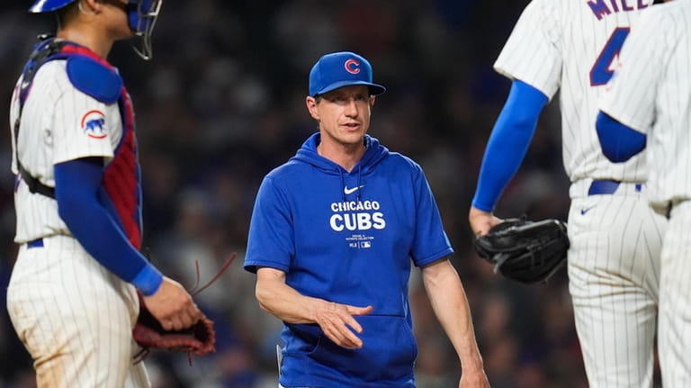 Chicago Cubs manager Craig Counsell takes the mound for a...