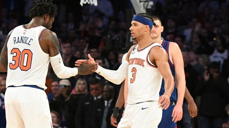 Knicks forward Julius Randle and guard Josh Hart react as...