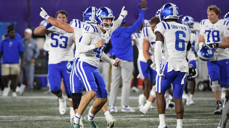 Duke punter Kade Reynoldson (41) celebrates with safety Leon Griffin...