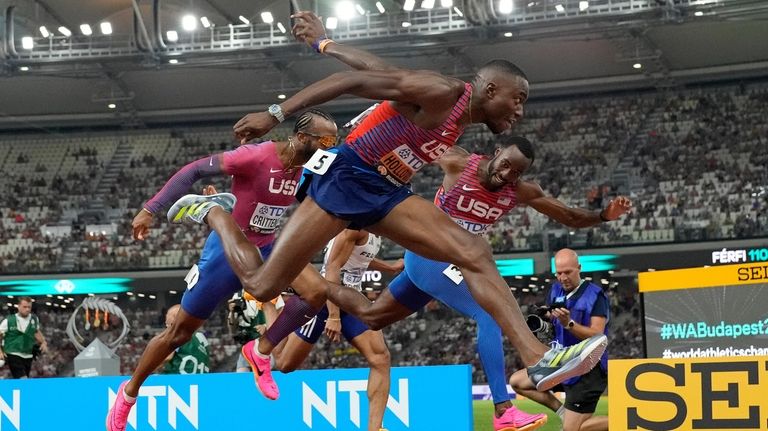 Grant Holloway, of the United States cross the line to...