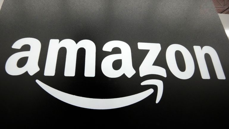 File - The Amazon logo is displayed at a Best...