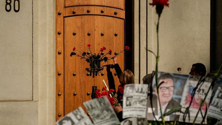 Red carnations are placed at the eastern entrance of La...