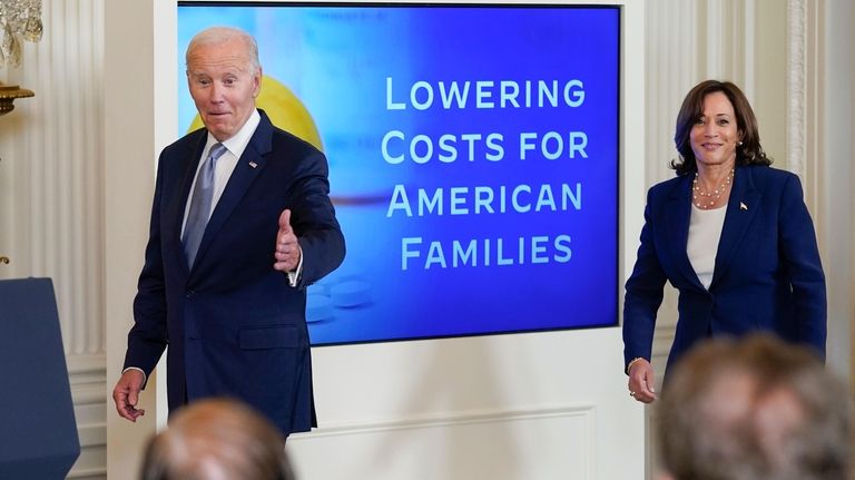 President Joe Biden, followed by Vice President Kamala Harris, arrives...