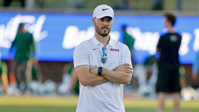 Then-SMU offensive coordinator Garrett Riley watches players practice prior to...