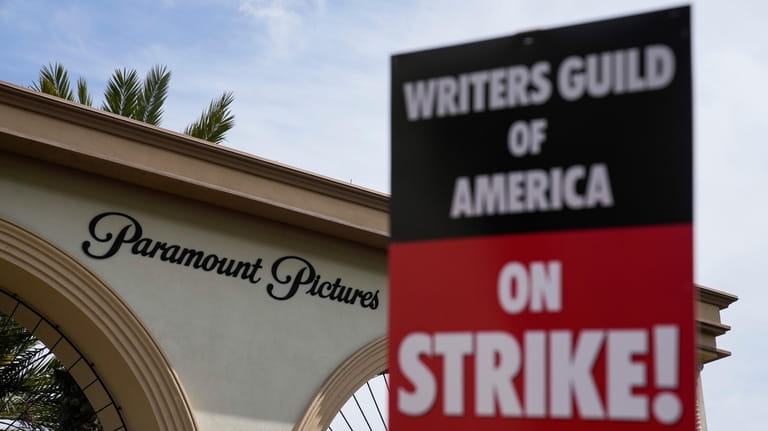 Members of the The Writers Guild of America picket outside...