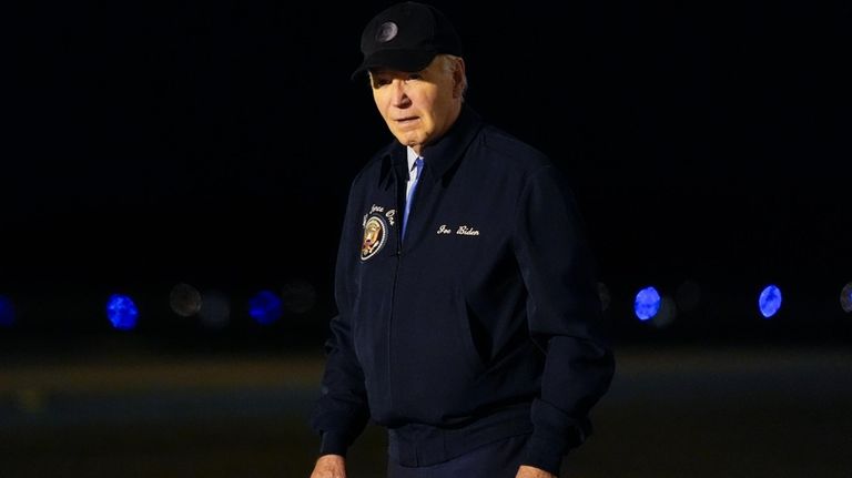 President Joe Biden walks to his car after stepping off...