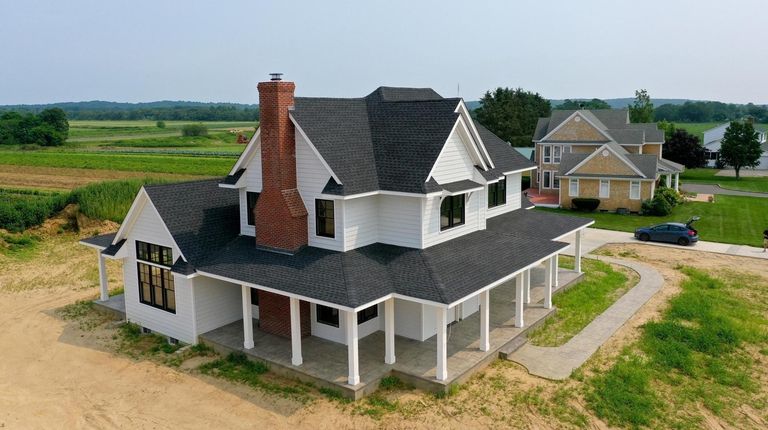 This newly built three-bedroom, 2½-bathroom farmhouse on Reeves Avenue in...