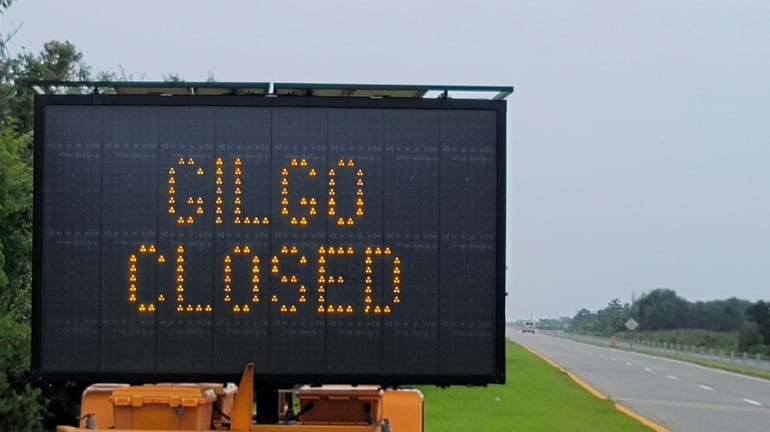 Sign on Ocean Parkway stating Gilgo State Park is closed.