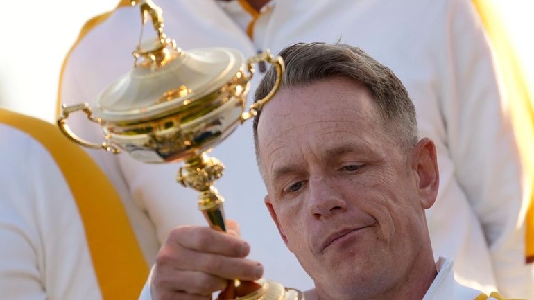 Europe's Team Captain Luke Donald holds and looks at the...