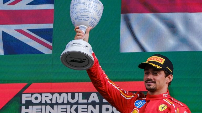 Ferrari driver Charles Leclerc of Monaco celebrates on the podium...